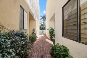 a brick path between two buildings with a person walking down it at Private Room & Entrance in Marina Del Rey in Los Angeles