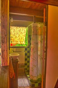 a bathroom with a sink and a shower curtain at Montezuma Heights in Montezuma