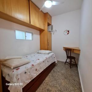 a small bedroom with a bed and a desk at Residencial Liberty Barra da Tijuca in Rio de Janeiro