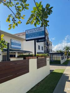 a sign for a city ville apartments in front of a building at Cityville Apartments & Motel in Rockhampton