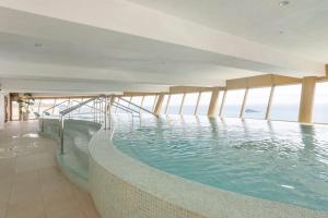 a swimming pool on the top of a building at InTempo Luxury Sky View & Spa Resort in Benidorm