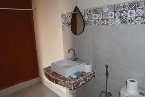 a bathroom with a sink and a toilet at Chalés Aconchego in Pirenópolis +107 photos