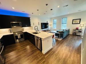 a kitchen with a sink and a living room at Downtown Denver Smart House in Denver