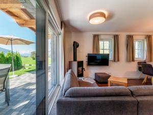 a living room with a couch and a tv at Chalet Lengberg B1 in Niedernsill