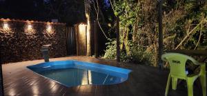 a blue tub sitting on a deck at night at Casa Canastra in Vargem Bonita