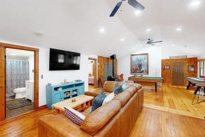 ein Wohnzimmer mit einem Sofa und einem Tisch in der Unterkunft Long Island Road Abode in Moultonborough