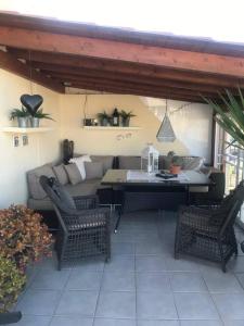 a patio with a couch and a table and chairs at Perchel Sport in Las Palmas de Gran Canaria