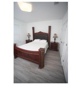 a bedroom with a large bed and two night stands at room in residential home in Orlando