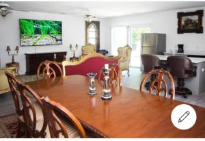 a dining room and kitchen with a wooden table and chairs at room in residential home in Orlando