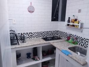 a kitchen with a sink and a counter top at APARTAMENTO ITAIGARA in Salvador