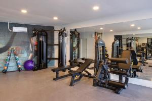 a gym with several tread machines and a mirror at Hotella Resort & Spa in Belek