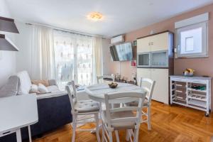 a kitchen and living room with a table and chairs at Apartment in Crikvenica 42448 in Crikvenica