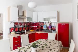 a kitchen with red cabinets and a red refrigerator at E&E Apartments in Ljubljana