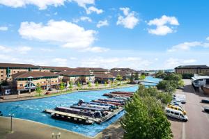 a group of boats in a river with buildings at Luxury stay with scenic views in Brierley Hill