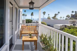 a porch with a table and a bench on it at Catalina Island Inn in Avalon