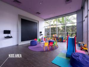 a classroom with a chalkboard and a play room with chairs at Icon Vallarta Beach front By Bamboo Skylife in Puerto Vallarta