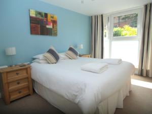 a bedroom with a large white bed with a window at Brunswick Apartments in Edinburgh