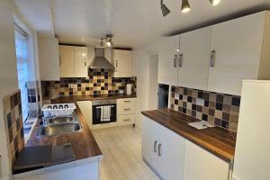 a kitchen with a sink and a counter top at Alfred House in Ripley