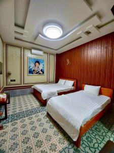 a hotel room with two beds and a ceiling at KQ hostel in Ho Chi Minh City