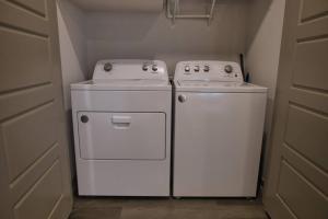 two white appliances sitting next to each other in a kitchen at Optimum - Rock Out and Relax! in Birmingham