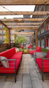 a patio with red couches in a building at Optimum - Rock Out and Relax! in Birmingham