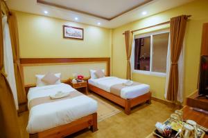 Un pat sau paturi într-o cameră la Paradise Boutique Hotel