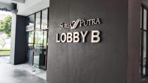 a building with a sign on the side of it at Sg Buloh Cozy Apartment WiFi & Netflix (Rahman Putra) (6pax) in Sungai Buluh