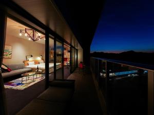 a living room with a view of the ocean at night at SETOUCHI KEIRIN HOTEL 10 by Onko Chishin in Tamano