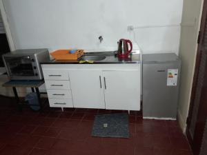 a small kitchen with a sink and a refrigerator at Centro in Mercedes