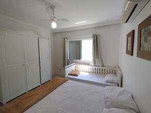 a bedroom with a large bed and a window at Casa Sol Nascente in Cabo Frio