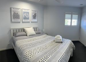 a white bedroom with a large bed in it at Unit 4 - Manly Boutique Apartments in Brisbane