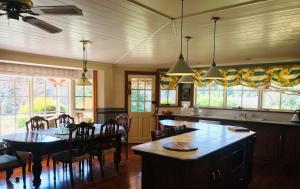a kitchen with a table and a dining room at Hawk's Nest Bed & Breakfast in Bathurst