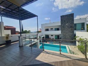 a view from the balcony of a house with a swimming pool at Habitaciones Casa Blanca Oaxtepec Tlayacapan in Oaxtepec