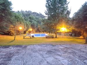 a park with a picnic table and a pool at Beautiful 2-Bed House - Marco de Canaveses in Marco de Canaveses