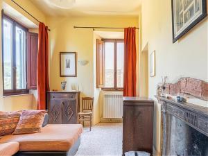 a living room with a bed and a fireplace at Luxury Retreat Montevettolini in Montevettolini +32 photos