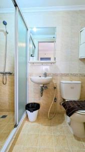 een badkamer met een toilet, een wastafel en een douche bij Cottonwood Japandi Apartment at Majesty 1222 in Bandung