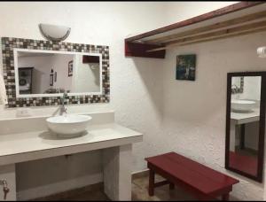 a bathroom with a sink and a mirror at Rural cotage and sandy bay in Tela +15 photos
