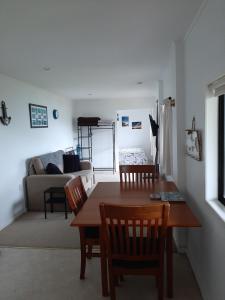 a living room with a table and chairs and a couch at A Sea View B&B in Picton