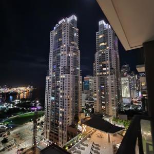 a city skyline at night with tall buildings at Ocean View Downtown Apt on 23rd Floor with Balcony, Rooftop Pool, Kitchen, Gym, & Restaurants in Miami