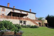 a large brick house with a grass yard in front of it at El Alto de Marín in Hoznayo