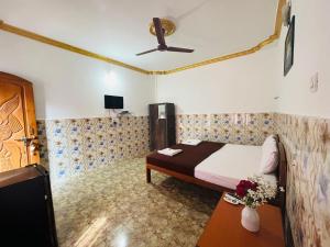 a bedroom with a bed and a ceiling fan at Casa De Calangute Hotel in Calangute