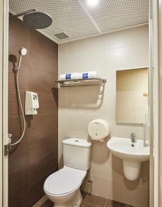 a bathroom with a toilet and a sink at ibis budget Singapore West Coast in Singapore