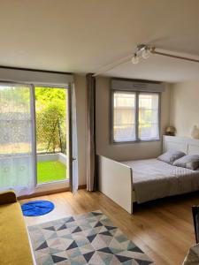 a bedroom with a bed and two large windows at Appartement Disneyland Paris Val d'Europe La vallée Village parking 500m gare Val d'Europe in Montévrain