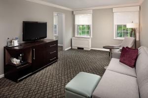 a living room with a couch and a flat screen tv at The Westin Governor Morris, Morristown in Morristown