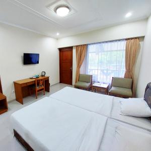 Postel nebo postele na pokoji v ubytování Sangga Buana Resort & Convention Hotel