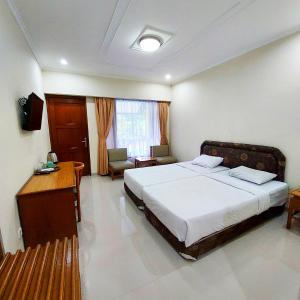 Postel nebo postele na pokoji v ubytování Sangga Buana Resort & Convention Hotel