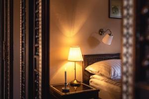 a bedroom with a bed with a lamp and a mirror at Casa Johann, your charming holiday home in Cund in Cund +4 photos