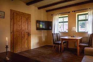 a living room with a wooden table and a television at Casa Johann, your charming holiday home in Cund in Cund