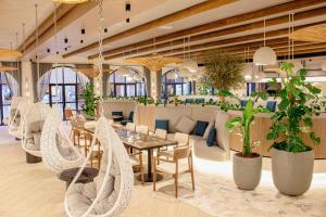 a restaurant with a table and chairs and plants at Ibis World Trade Centre in Dubai