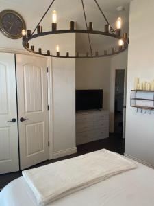 a bedroom with a bed and a chandelier at Field Stone in Oklahoma City